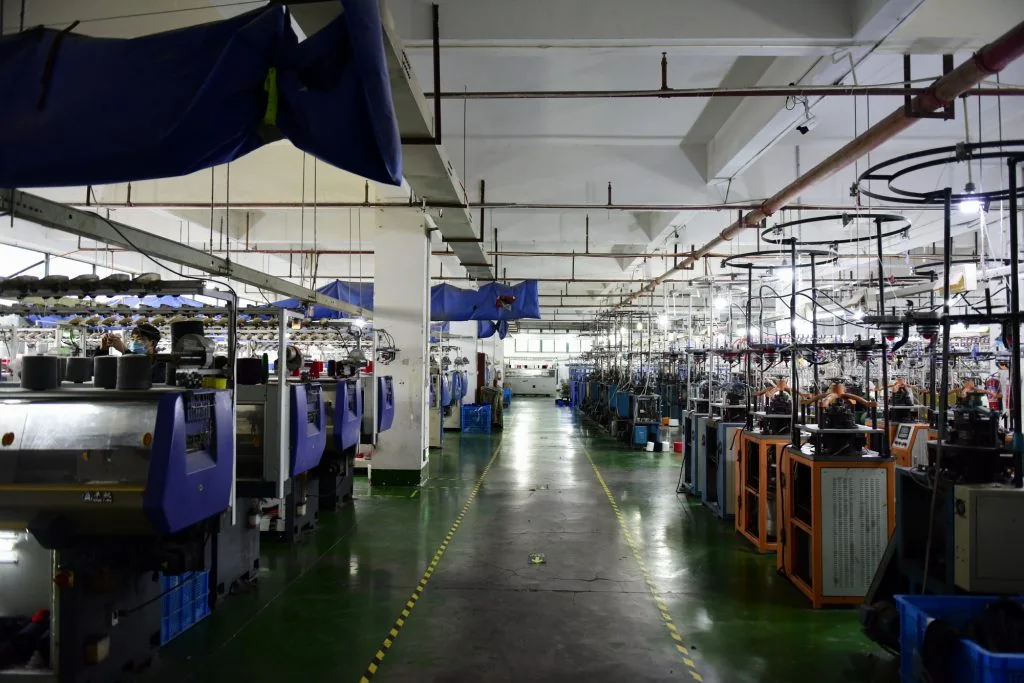 Beanie knit panels coming off the knitting machine